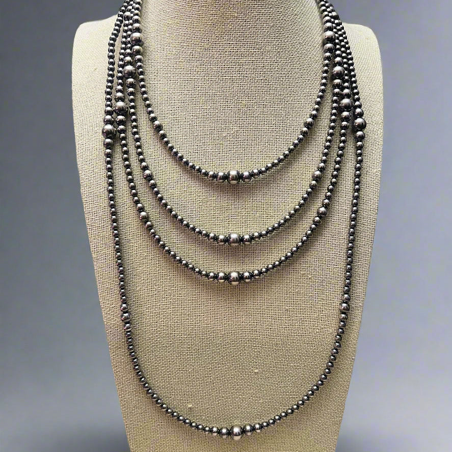 Navajo Pearls and Sterling Pearls - Cowhide and Conchos
