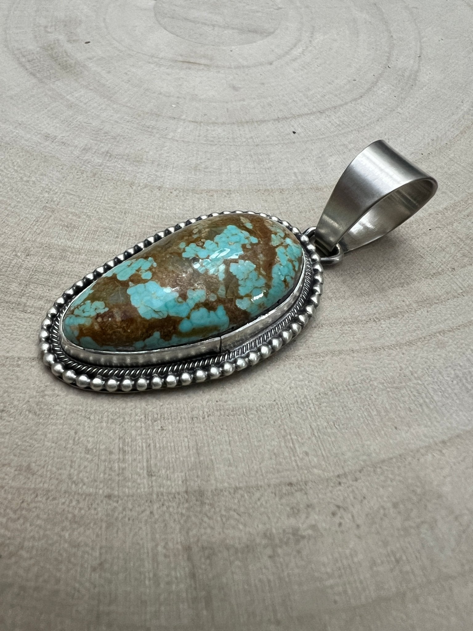Daniel Benally Navajo Sterling Silver Pendant with 8 Mine Turquoise — 2 1/4" × 1" (Hallmark) - Cowhide and Conchos