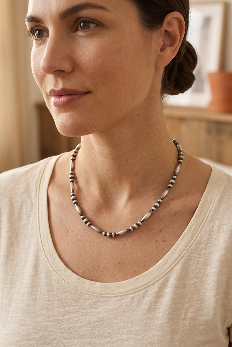 Close-up of the Cowhide & Conchos Sterling Silver Torpedo Bead Necklace with sterling pearl accents — timeless Western detail.