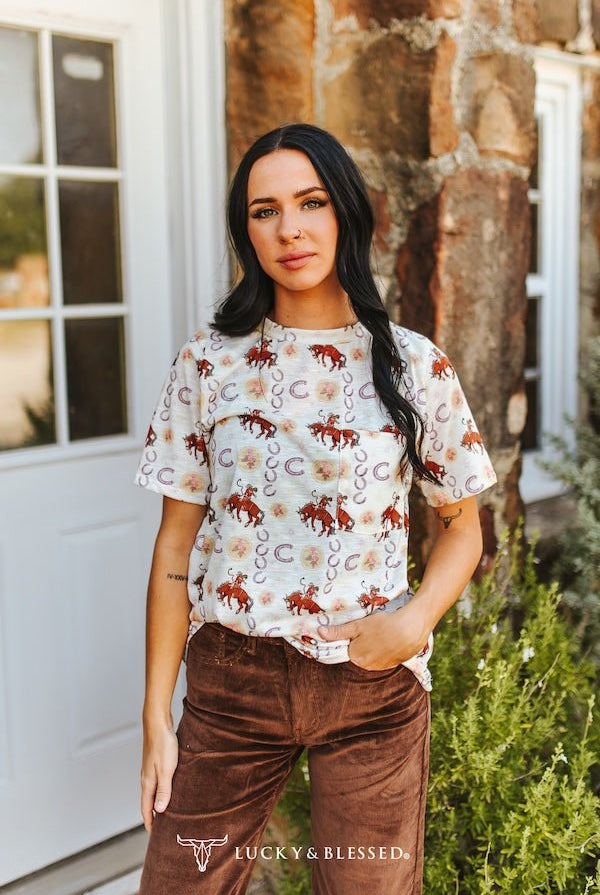 Ivory Cowboy & Horseshoe Printed Short Sleeve Front Pocket Tee - Cowhide and Conchos