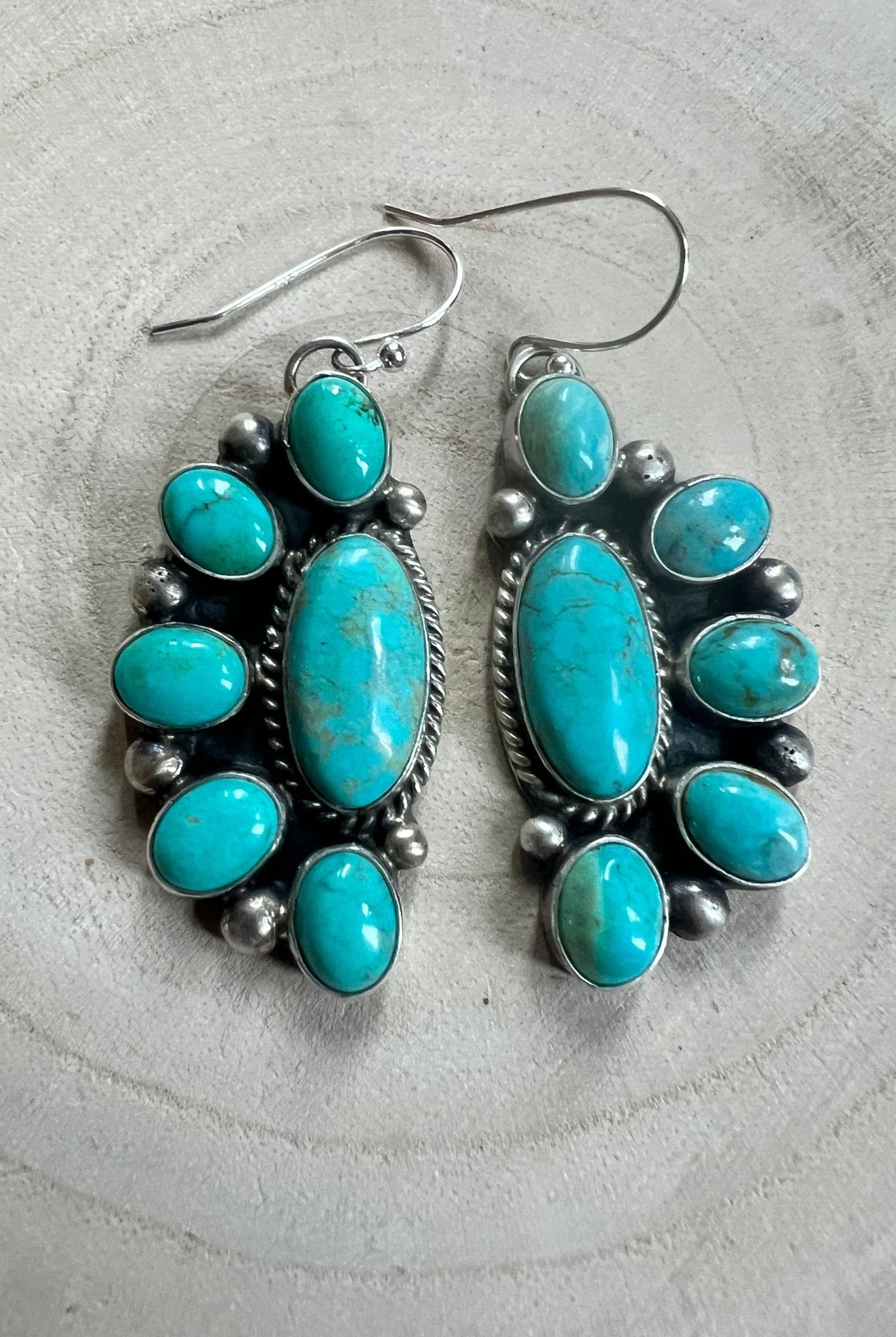 Kathleen Livingston Navajo Sterling Silver Earrings with Sonoran Gem Turquoise — 2" × 3/4" (Hallmarked) - Cowhide and Conchos