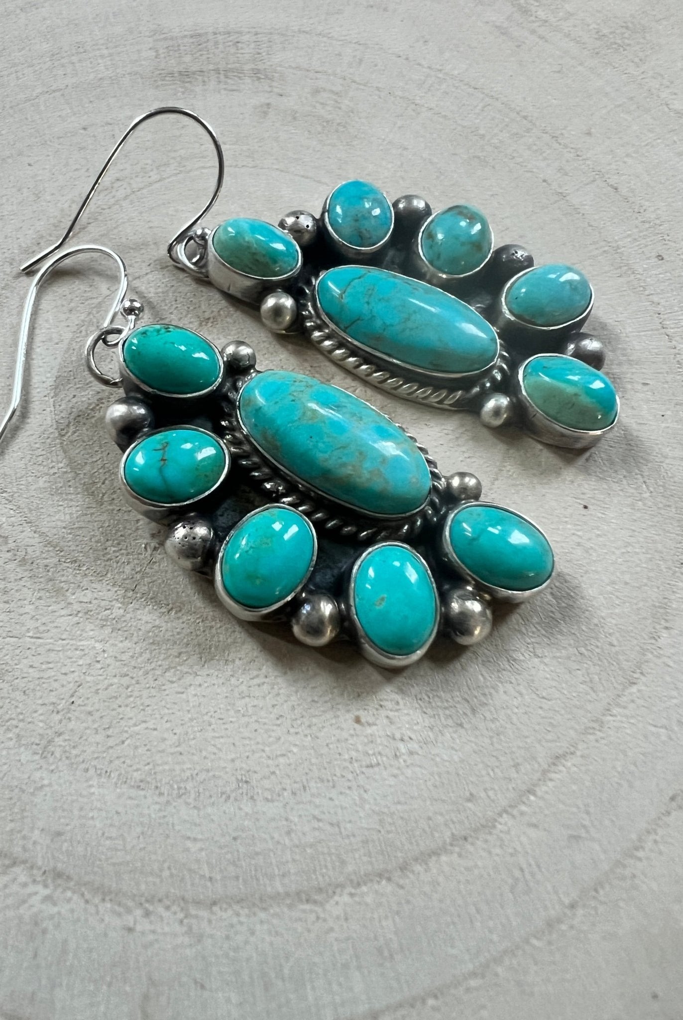 Kathleen Livingston Navajo Sterling Silver Earrings with Sonoran Gem Turquoise — 2" × 3/4" (Hallmarked) - Cowhide and Conchos