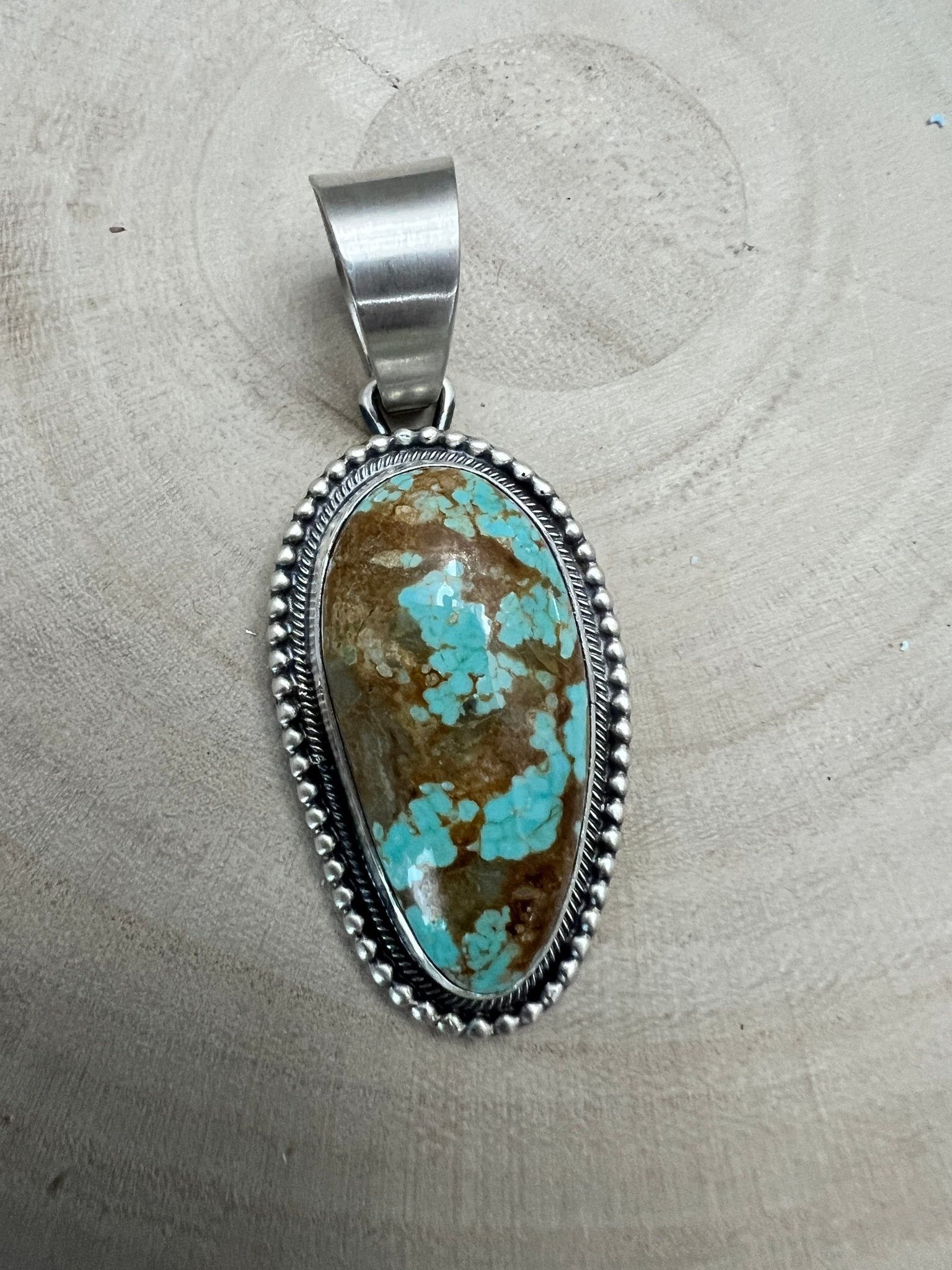 Daniel Benally Navajo Sterling Silver Pendant with 8 Mine Turquoise — 2 1/4" × 1" (Hallmark) - Cowhide and Conchos