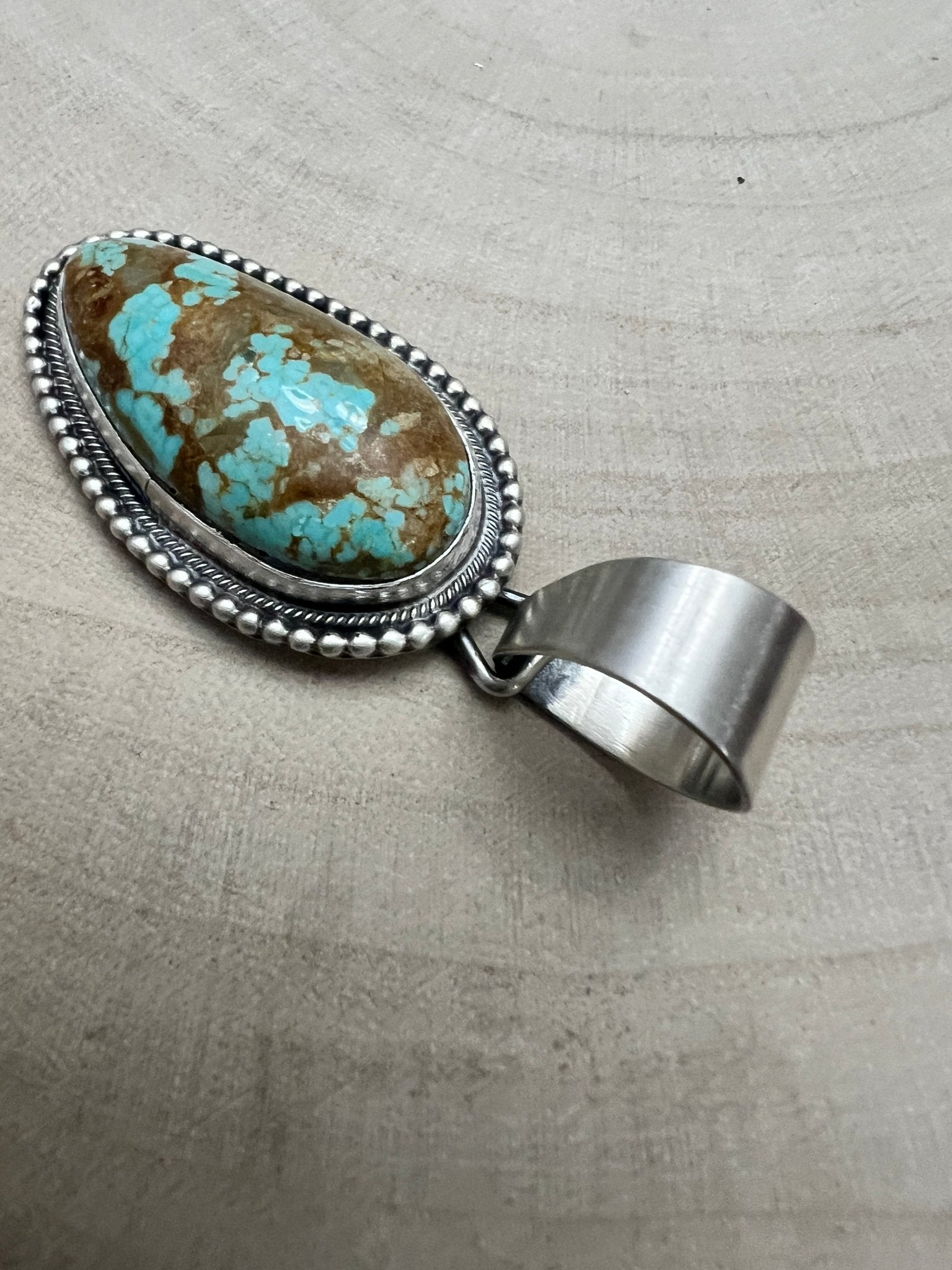 Daniel Benally Navajo Sterling Silver Pendant with 8 Mine Turquoise — 2 1/4" × 1" (Hallmark) - Cowhide and Conchos