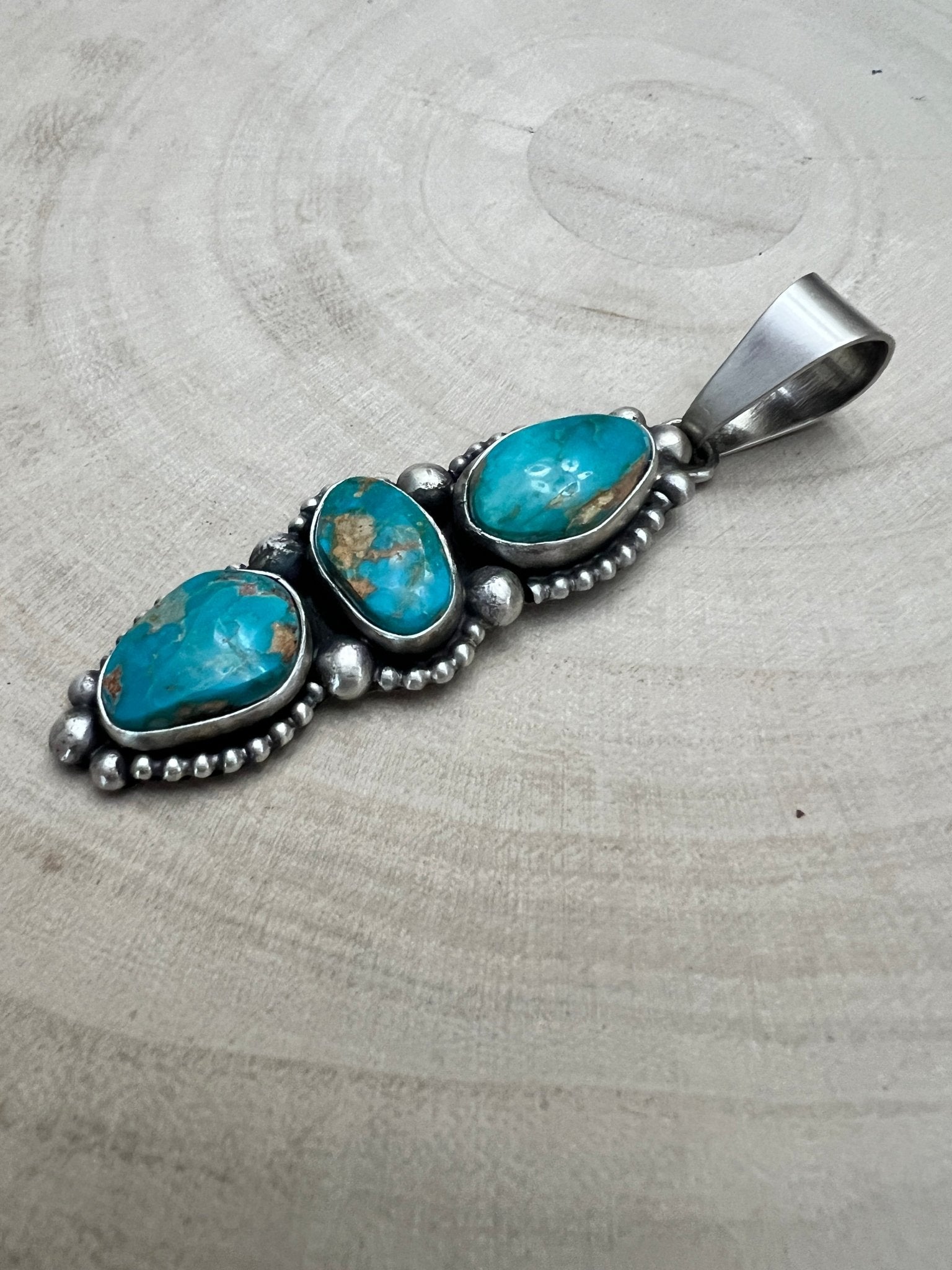 Darrin Livingston Navajo Sterling Silver Pendant with Natural Royston Turquoise — 3" × 3/4" (Hallmark) - Cowhide and Conchos