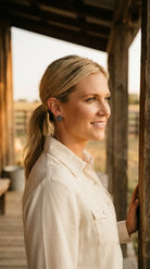 Ranch portrait wearing the Cowhide & Conchos cross stud earrings — antiqued silver faith-and-western style.