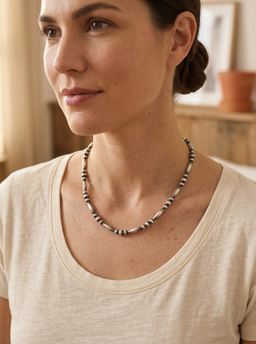 Close-up of the Cowhide & Conchos Sterling Silver Torpedo Bead Necklace with sterling pearl accents — timeless Western detail.