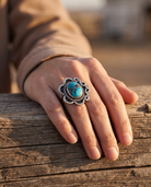 Close-up of the Cowhide & Conchos hand-stamped sterling silver turquoise ring — up close.