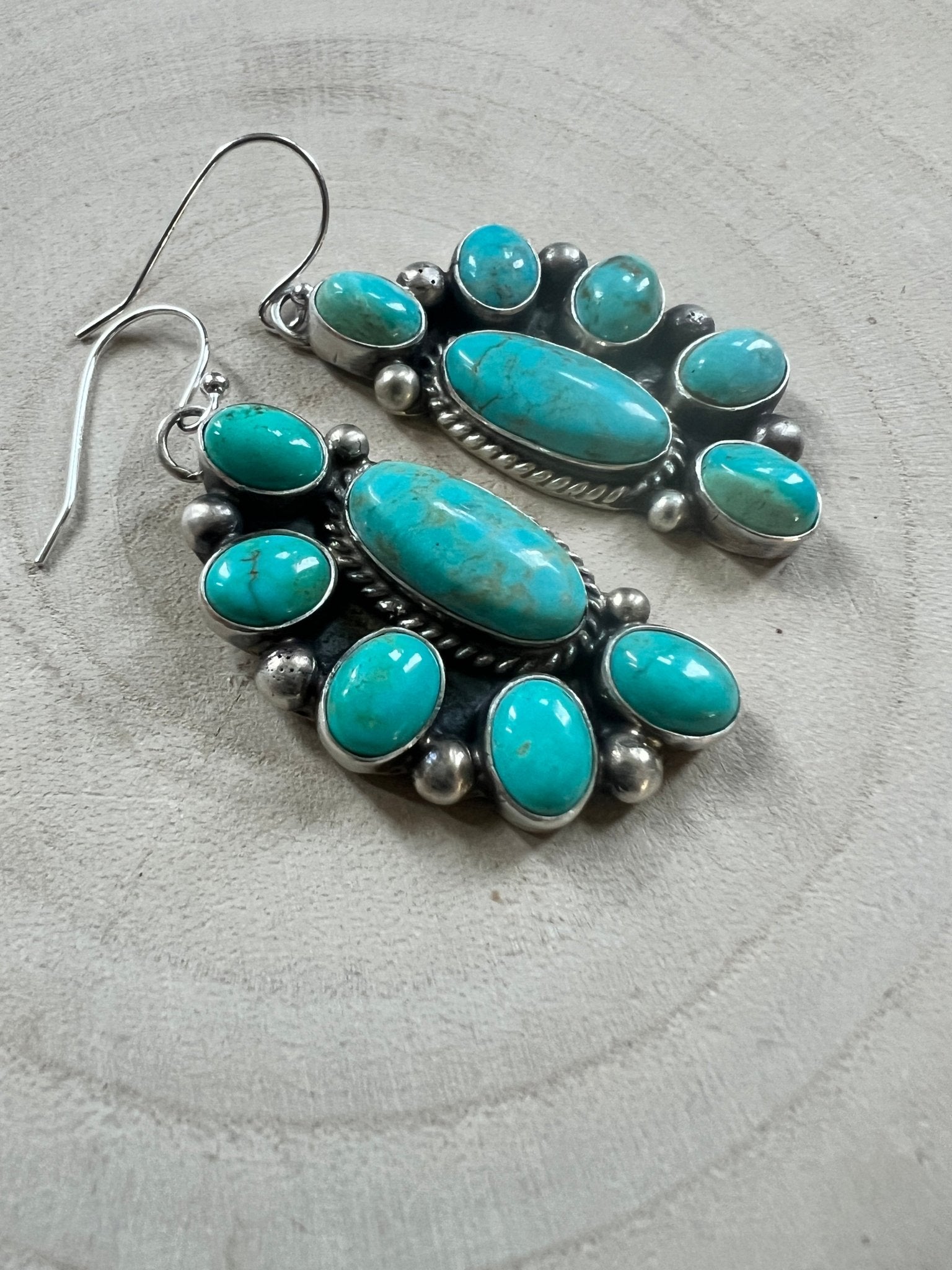 Kathleen Livingston Navajo Sterling Silver Earrings with Sonoran Gem Turquoise — 2" × 3/4" (Hallmarked) - Cowhide and Conchos