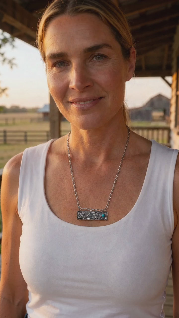 Western faux tooled bar necklace with faux turquoise worn on a model, 18 inch chain